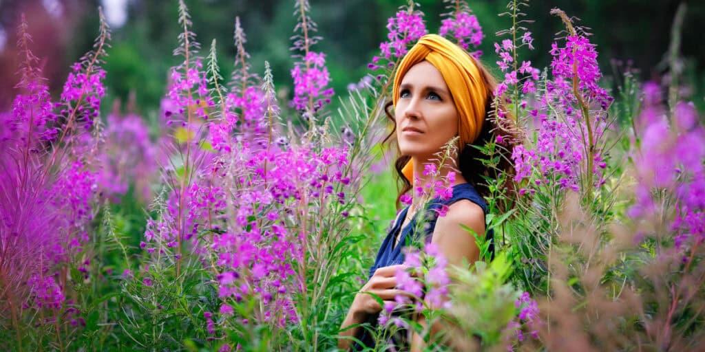 Woman practicing mindful observation in a flower field