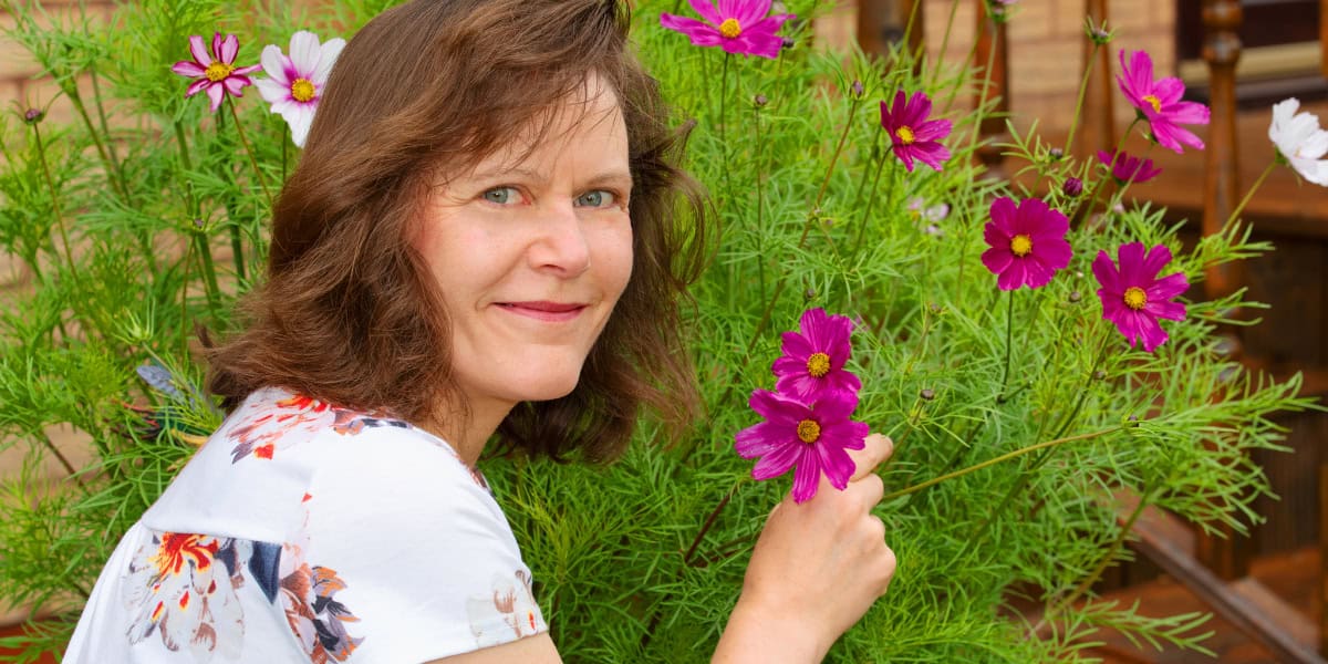 Mindful woman smelling flowers