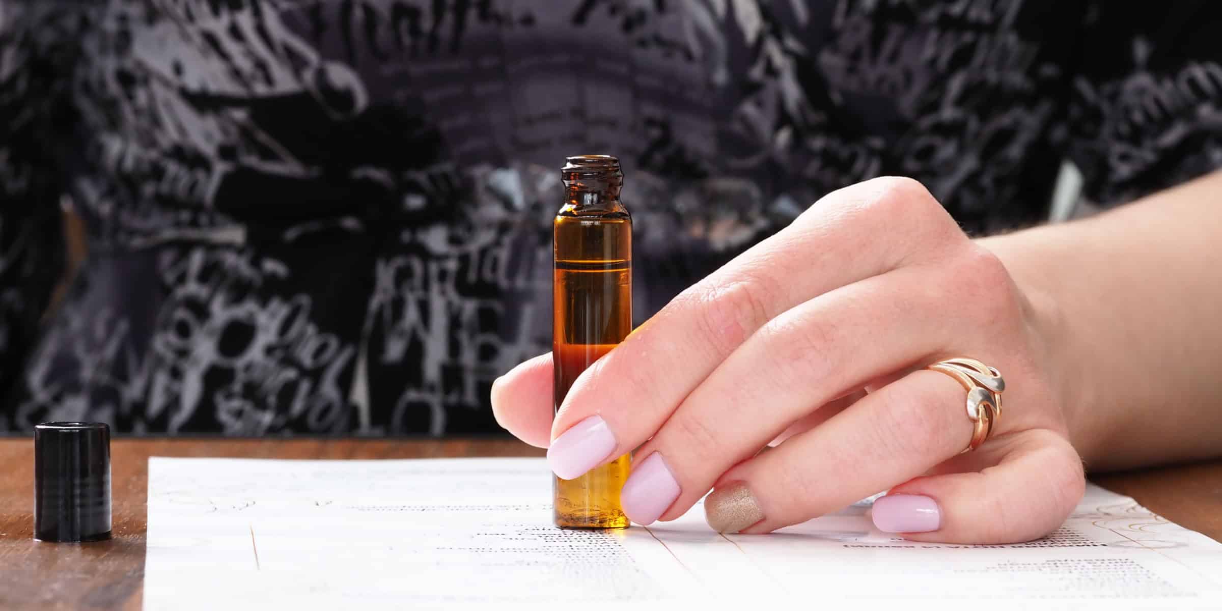 womans hand aromatherapy bottle