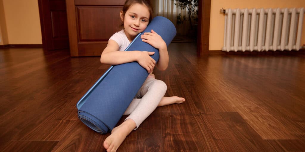 child with yoga mat