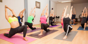 A group of people doing yoga in a room.