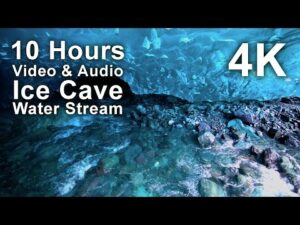 View of a clear stream flowing through an ice cave, with text overlay stating "10 Hours Video & Audio Ice Cave Water Stream 4K.
